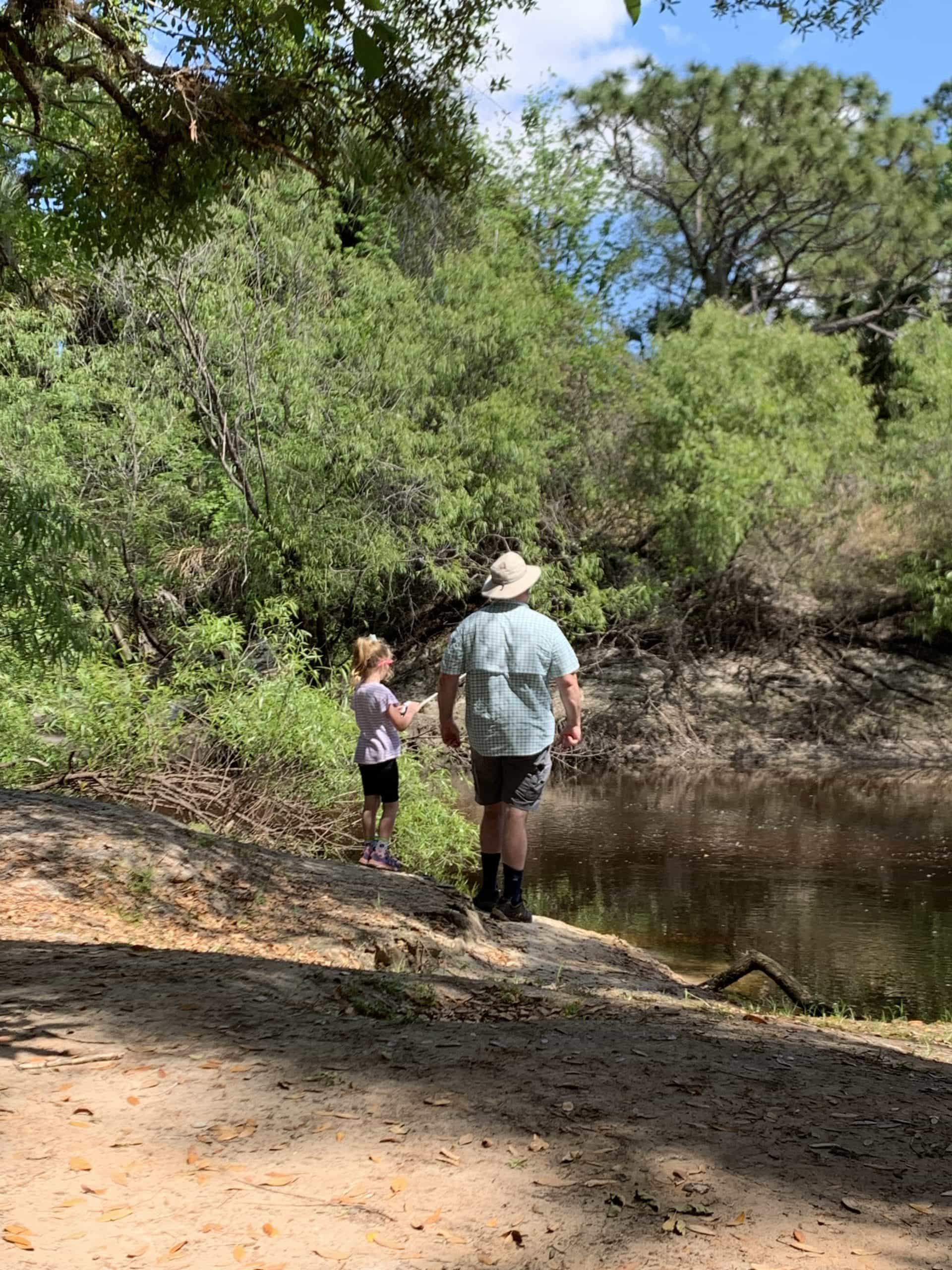Daddy teaching daughter to fish for shad