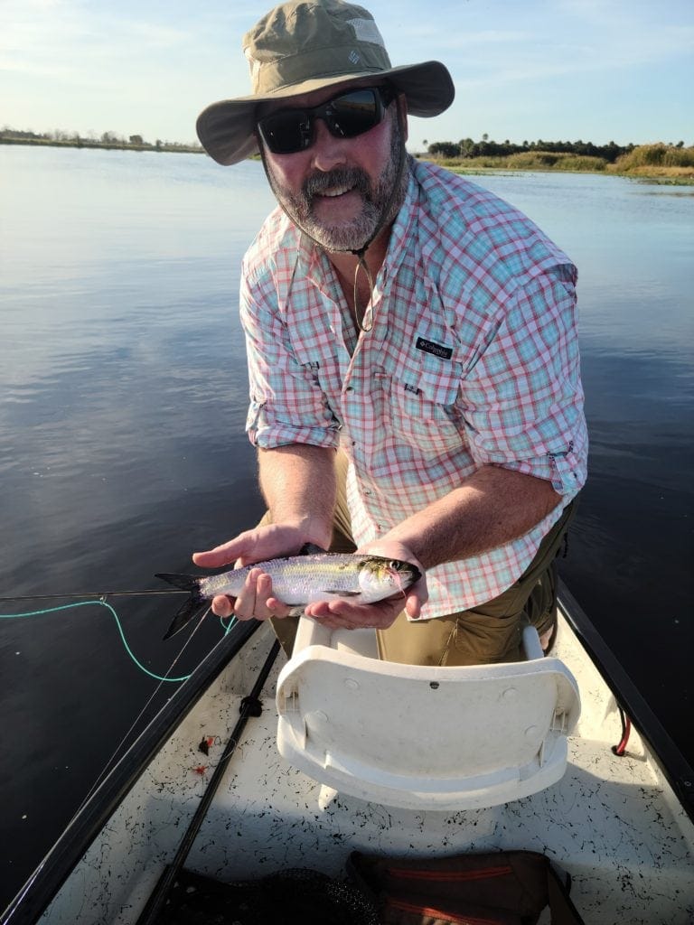 author with a hickory shad caught with a fly rod