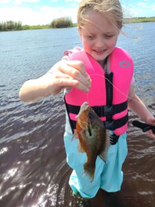 Evelyn holding the panfish she caught